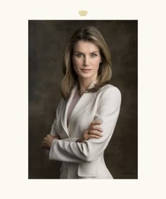 a woman with her arms crossed posing for a photo