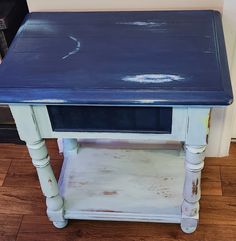 an old blue table with white paint on it