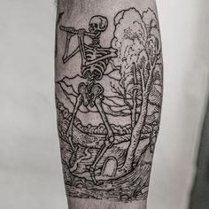 a man's leg with a skeleton tattoo on it and trees in the background