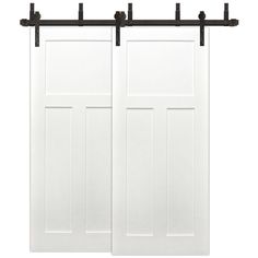 two white sliding doors with black hardware on each side and one door open to the other