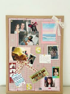 a bulletin board with pictures and magnets attached to the back of it's frame