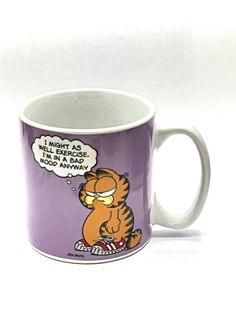 a purple coffee mug with a cartoon cat on it