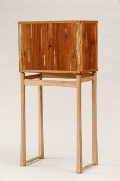 a small wooden shelf sitting on top of a white floor