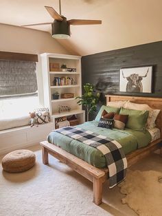 a bed room with a neatly made bed next to a window and a book shelf