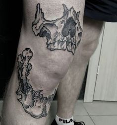 a man's leg with a skull and bones tattoo on the lower half of his leg