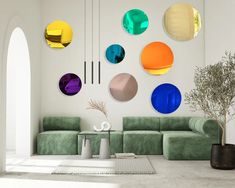 a living room filled with green couches and colorful circles on the wall