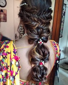 a woman with long hair in a flowered dress is shown from the back view