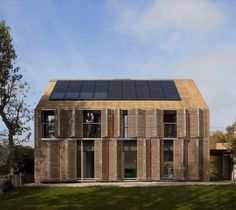 an image of a house that is made out of wood and has solar panels on the roof