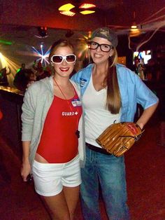 two women standing next to each other at a bowling game