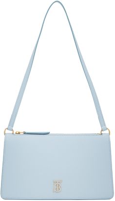 Grained calfskin shoulder bag in blue. Logo hardware at face. · Fixed shoulder strap · Zip closure · Card slot at interior · Buffed calfskin lining · Gold-tone hardware · H5.25 x W9 x D2 in Supplier color: Pale blue Powder Blue Handbag, Hanging Purses, Blue Crossbody Bag, Burberry Shoulder Bag, Burberry Outfit, Light Blue Wedding, Blue Handbags, Blue Purse, Winter Formal