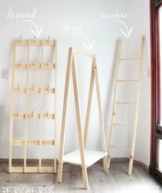 three wooden ladders sitting next to each other in front of a wall with writing on it