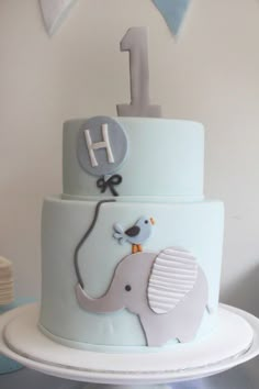 a blue and white cake with an elephant on it