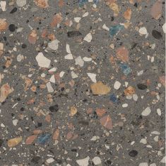 an asphalt surface with various colored rocks and gravel