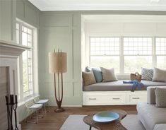 a living room filled with furniture and a fire place next to a white fireplace mantel