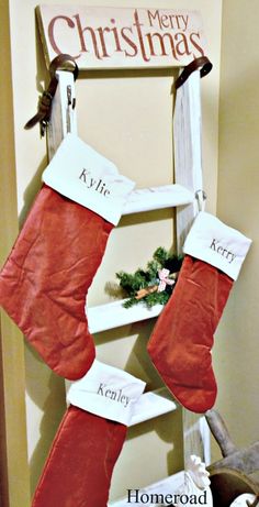 a christmas stocking hanging on the wall next to a sign that says merry christmas