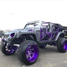 a gray and purple jeep parked in a parking lot