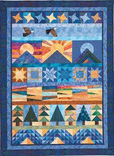 a quilted wall hanging with stars and mountains in the sky, on top of a blue