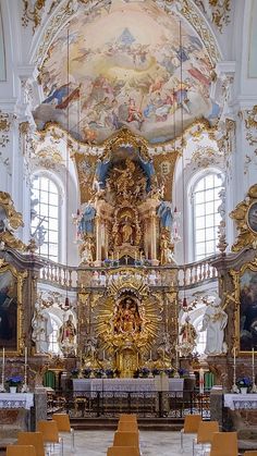 the interior of a church with gold and white decor