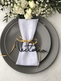 a place setting with napkins and flowers