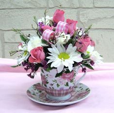 a coffee cup filled with pink and white flowers