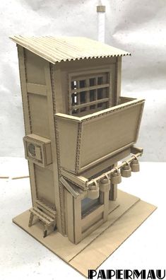 a paper model of a small building with windows