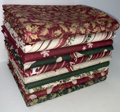 a stack of folded fabric sitting next to each other on top of a white table