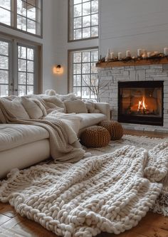 a living room filled with furniture and a fire place in the middle of the room