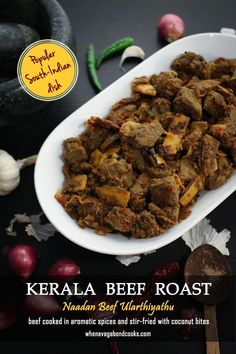 kerala beef roast with peanuts and garlic on the side, served in a white oval serving dish