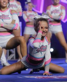 a group of cheerleaders are performing on stage