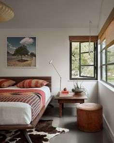 a bed sitting next to a window in a bedroom