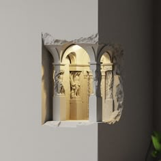 an arch in the wall with statues on it and a potted plant next to it