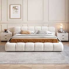 a white bed sitting on top of a wooden floor next to a dresser and lamp