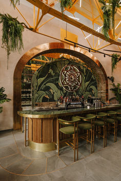 the bar is decorated with green plants and gold accents