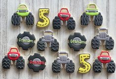 decorated cookies are arranged in the shape of trucks and tractors, with names on them