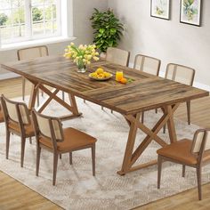 a wooden table with chairs around it in front of a white rug and potted plant