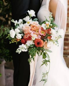 the bride and groom are holding their wedding bouquet