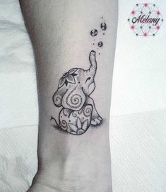 an elephant tattoo on the ankle with bubbles coming out of it's trunk and its trunk