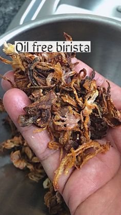 a person is holding out their hand full of dried food in front of the words oil free bristaa