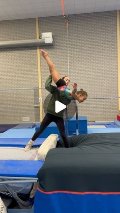 two people doing tricks on an inflatable trampoline