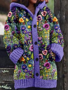 a woman standing next to a wooden fence wearing a purple jacket with flowers on it