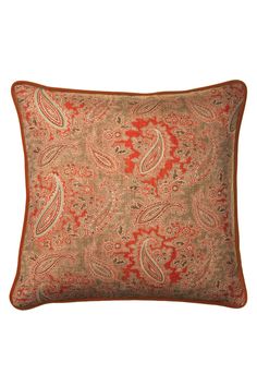 an orange paisley pillow on a white background