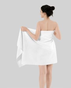 a woman in a white towel is standing