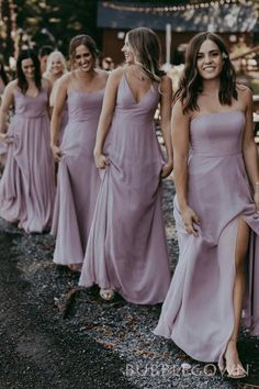 the bridesmaids are walking down the road together