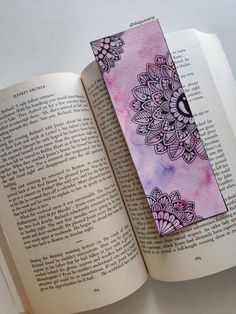 an open book with a pink and purple cover