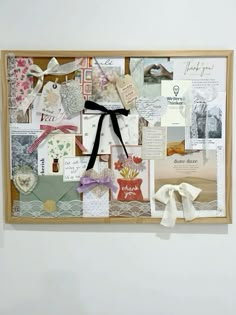 a wall hanging with many different types of cards and tags on it, including bows