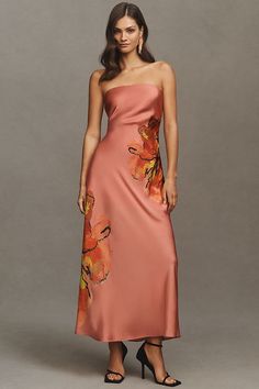 a woman in a strapless dress with flowers on it