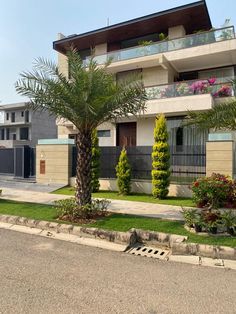 a large house with palm trees in the front yard