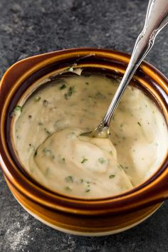 a spoon in a bowl filled with cream sauce