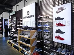 the inside of a nike store with shoes on display