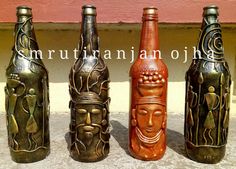 three bottles with carvings on them are sitting next to each other in front of a wall